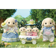 Flora Rabbit Family with father, mother, and three babies in blue checkered outfits with flower accessories outdoors.