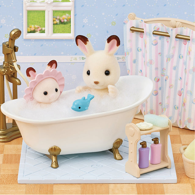 Bath & Shower Set with antique-style tub, two animal figures, bath toy, shampoo, and soap on tile floor.