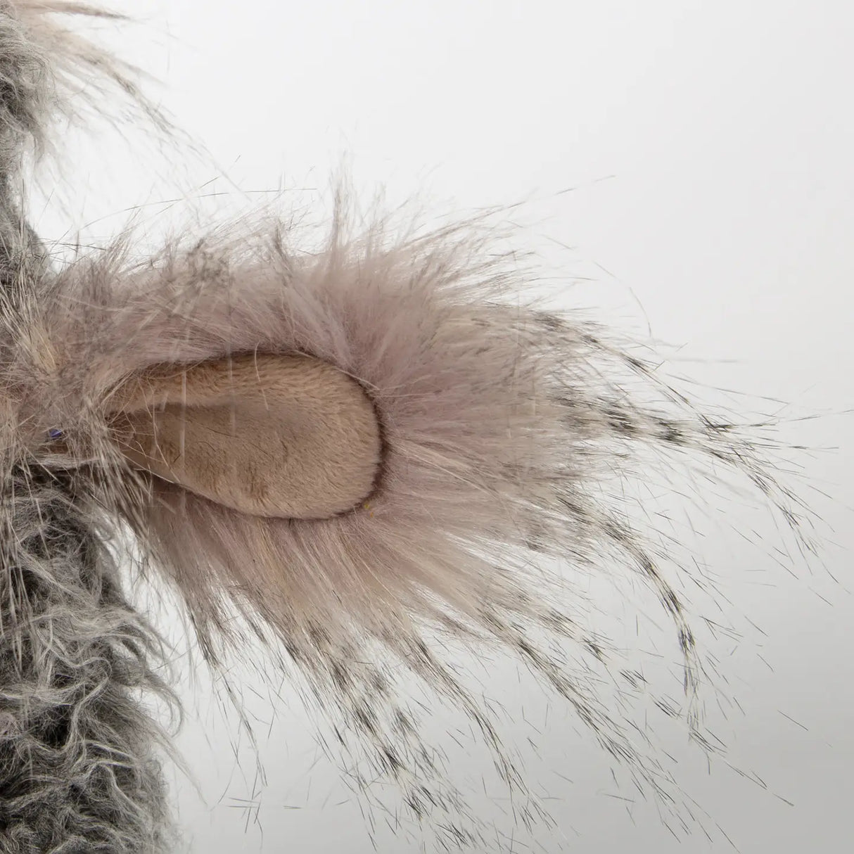 Close-up of soft, delicate plush wing detail of the Bird Slow Flyer with fluffy feathers and textured fabric.
