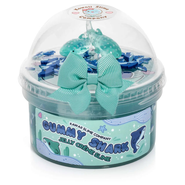 Gummy Shark Jelly Creme Slime in container with shark fimo slices, whale shark charms, and blue bow on top.
