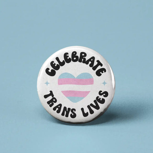 Button | Celebrate Trans Lives with a heart featuring the transgender flag colors on a white background