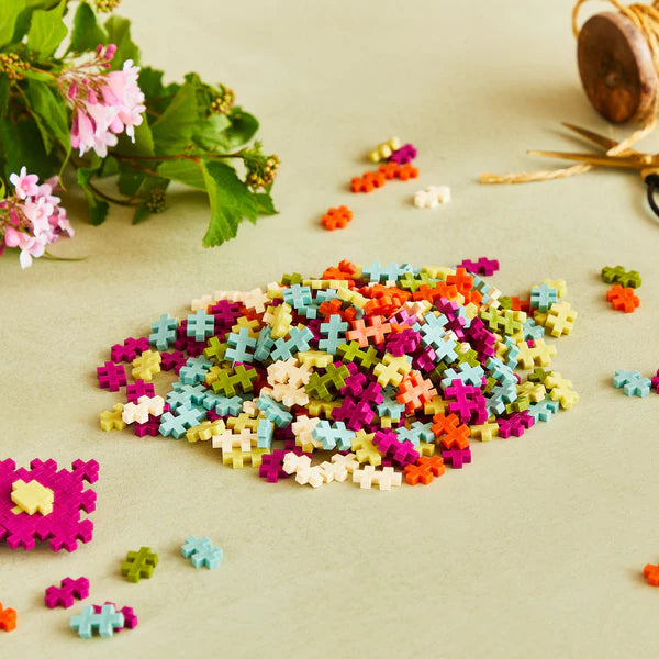 Plus Plus Botanica 240pc colorful building pieces in nature-inspired shades for creative 2D and 3D designs.