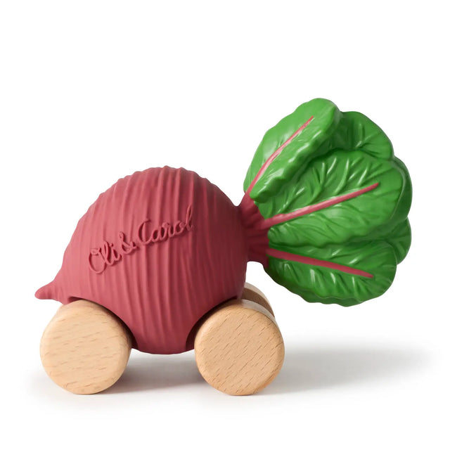 Hand-painted baby toy car shaped like a beetroot with wooden wheels and green leaves, made from natural materials