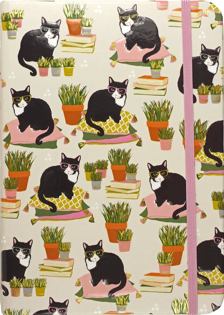 Journal cover with black and white cats wearing glasses sitting on colorful pillows among potted plants and books