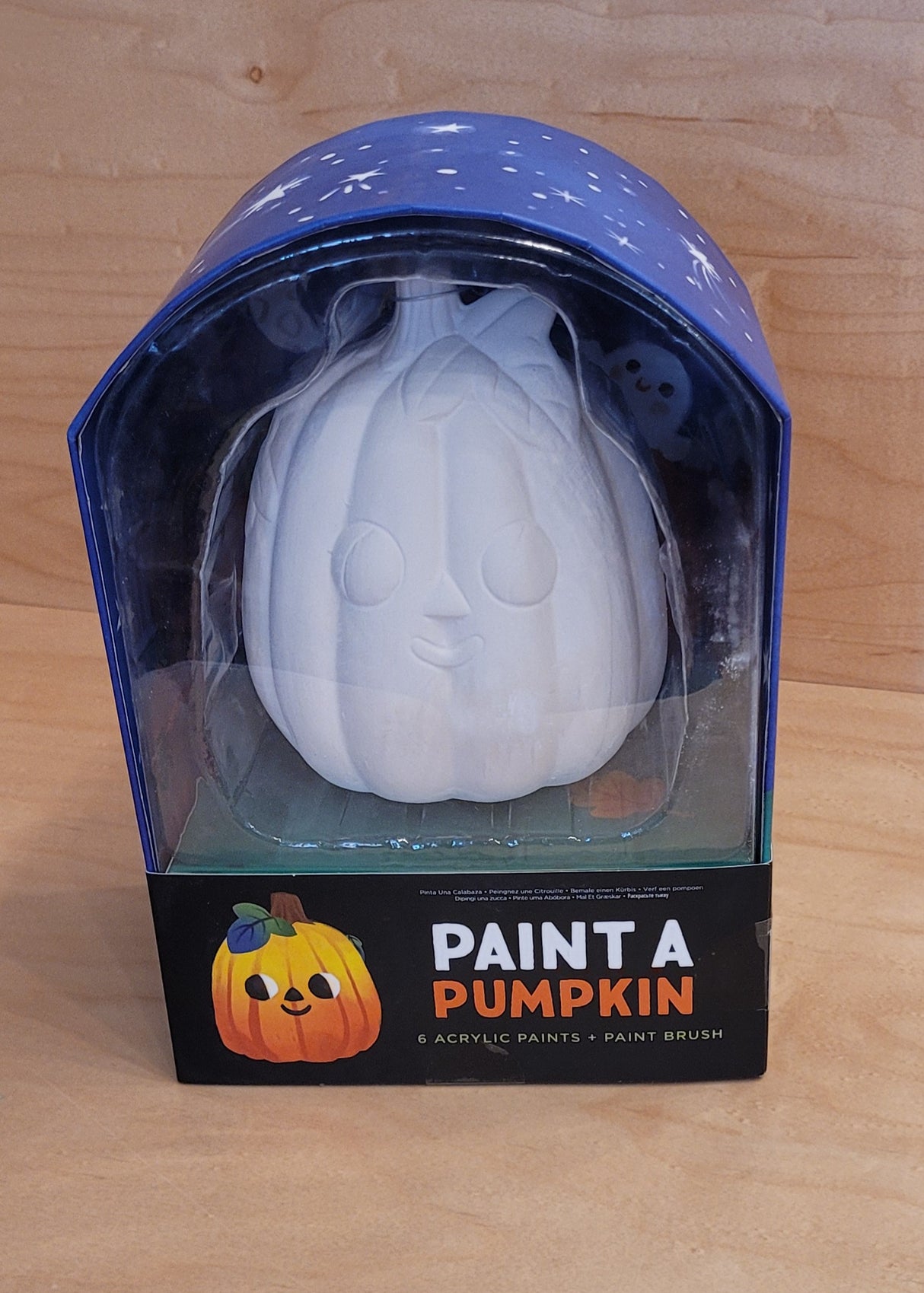 Unpainted ceramic pumpkin inside a decorative box ready for creative painting and seasonal crafting fun