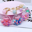 Paw Floaty KeyChain featuring colorful floating beads inside paw-shaped clear charm with keyring and clip attachment.