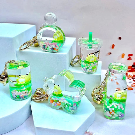 Frog Boba Floaty Keychain featuring assorted clear liquid designs with floating frog and colorful confetti inside.