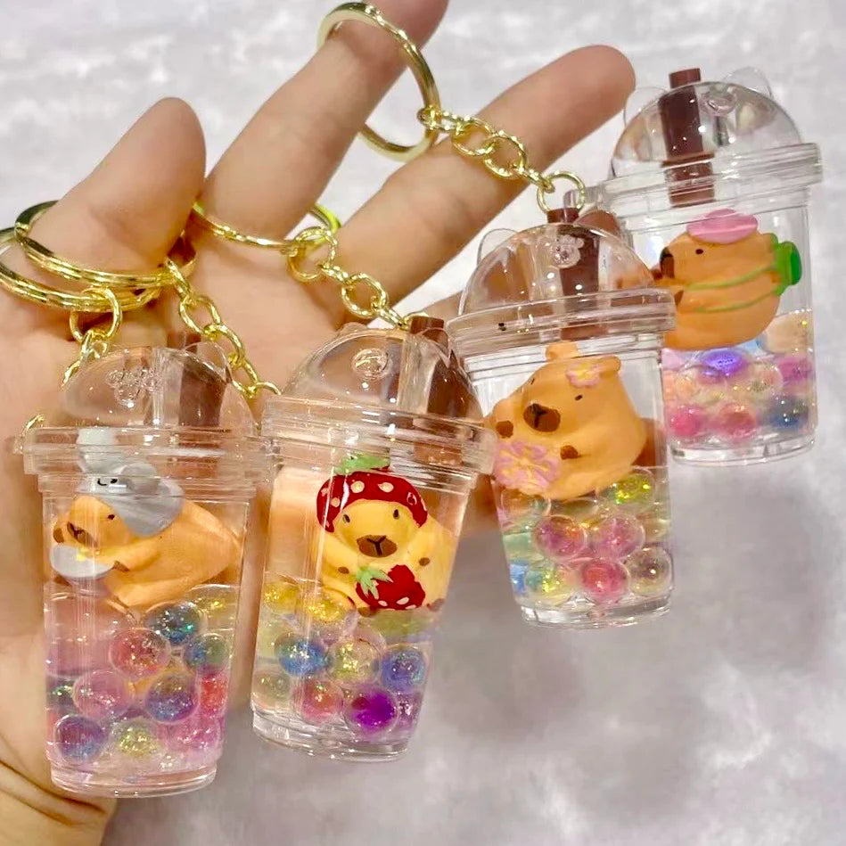 Capybara Boba Floaty Keychain featuring cute capybara figures in transparent bubble tea cups with colorful beads inside.