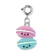 Macaron Buddies Charm features two smiling 3D pink and blue macarons with glitter and enamel details on a silver clasp.