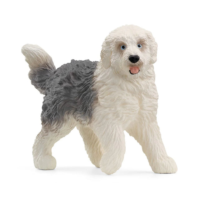 Old English Sheepdog figurine with fluffy white and gray fur, standing with mouth open as if inviting to play.