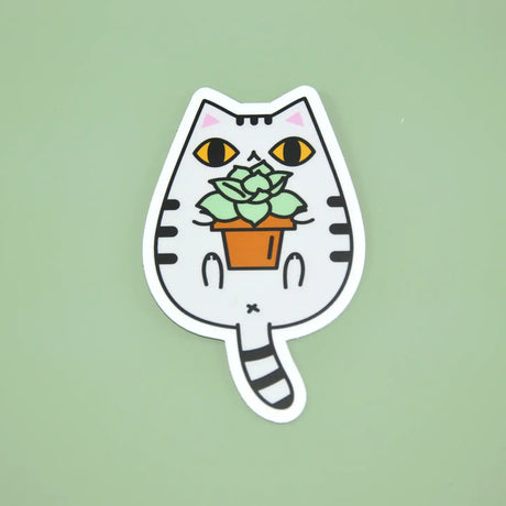 Gray Tabby Cat and Plant Sticker featuring a cute white tabby cat holding a potted green succulent plant on a green background.
