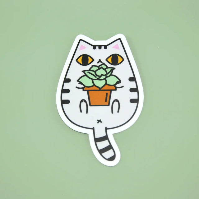 Gray Tabby Cat and Plant Sticker featuring a cute white tabby cat holding a potted green succulent plant on a green background.