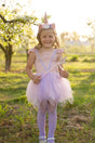 Pink Shimmer Unicorn Dress & Headband size 5-6 worn by smiling girl outdoors with wand and floral unicorn headband.