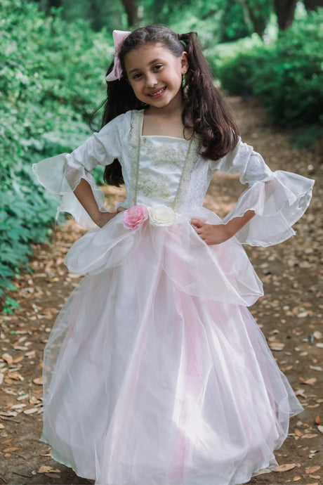 Golden Rose Princess Dress with soft pink skirt, floral waistband, and elegant sheer sleeves on smiling girl outdoors.