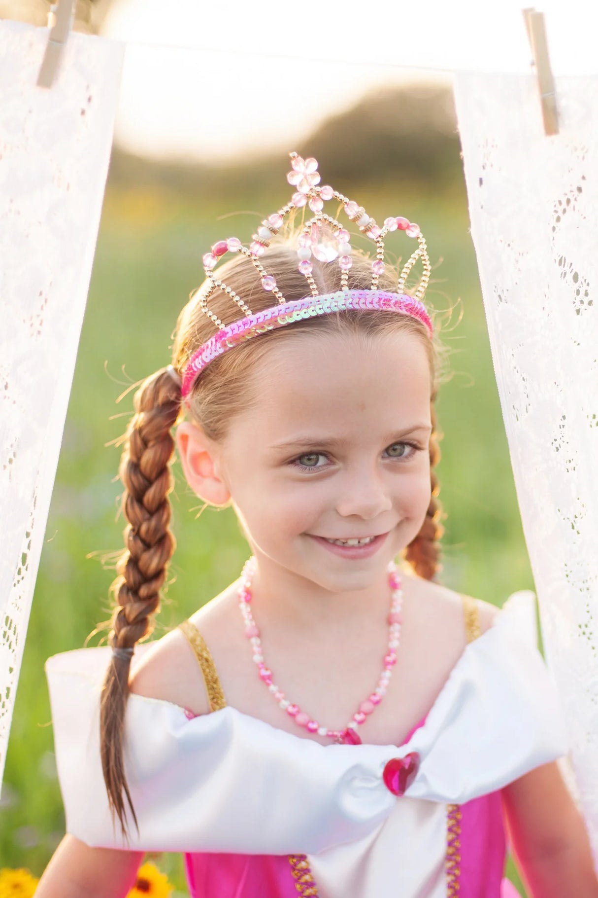 Smiling girl wearing a Fairy Princess Tiara with pink jewels and sequins, perfect for dress-up and play.
