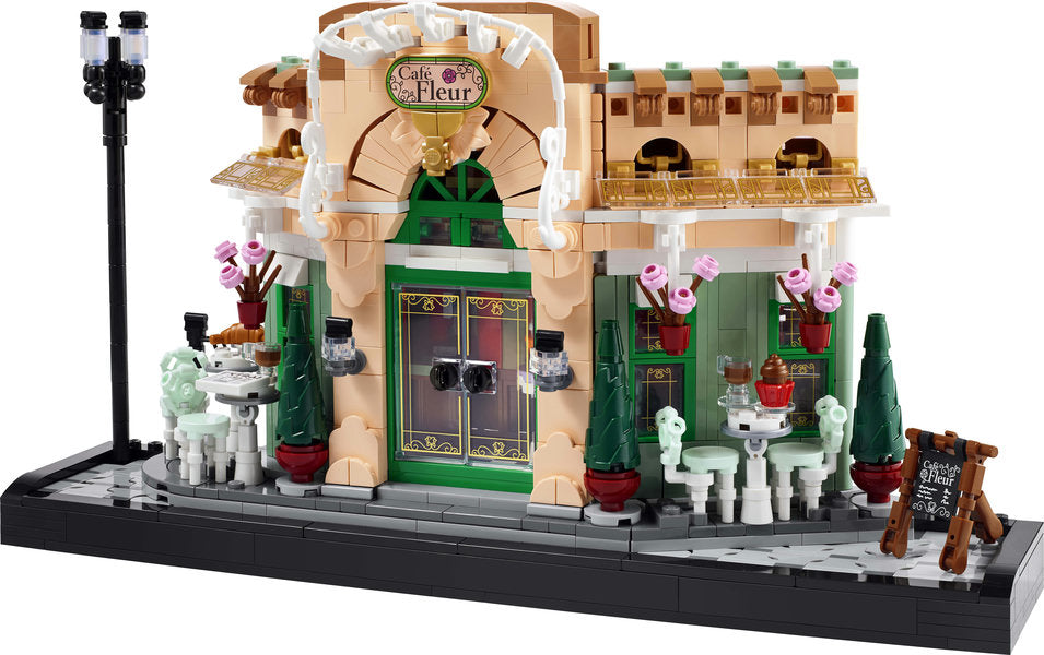 LEGO Icons French Cafe building kit with detailed facade, streetlight, outdoor seating, and flowerpots for shelf display.
