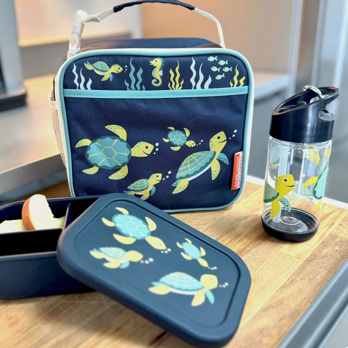 Insulated lunch tote with sea turtle design, matching snack box and water bottle for kids.