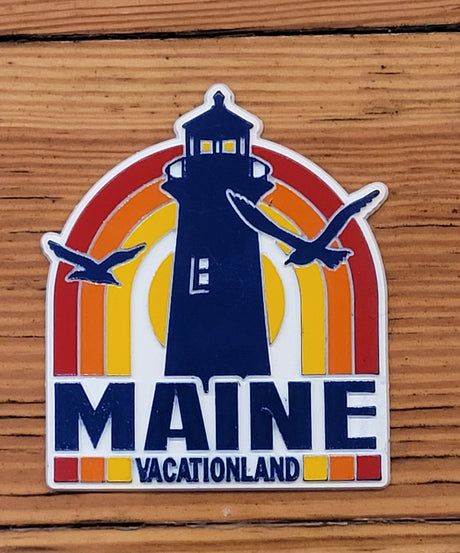 Maine Retro Lighthouse Magnet with vintage lighthouse, colorful sunset, and seagulls design on wood background.