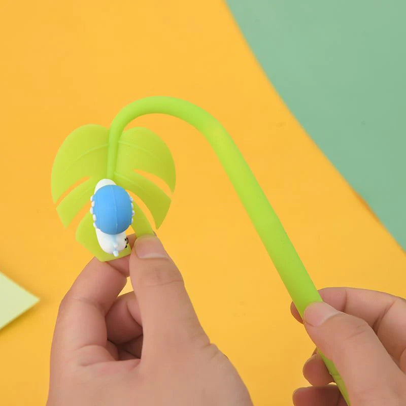 Close-up of hands holding an Insect Wiggle Gel Pen with a flexible green stem and blue insect topper.