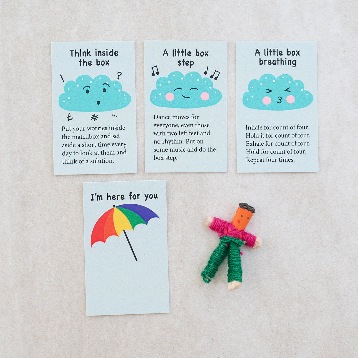 Don't Worry Doll Matchbox showing worry doll and stress tips cards with supportive messages and calming exercises.