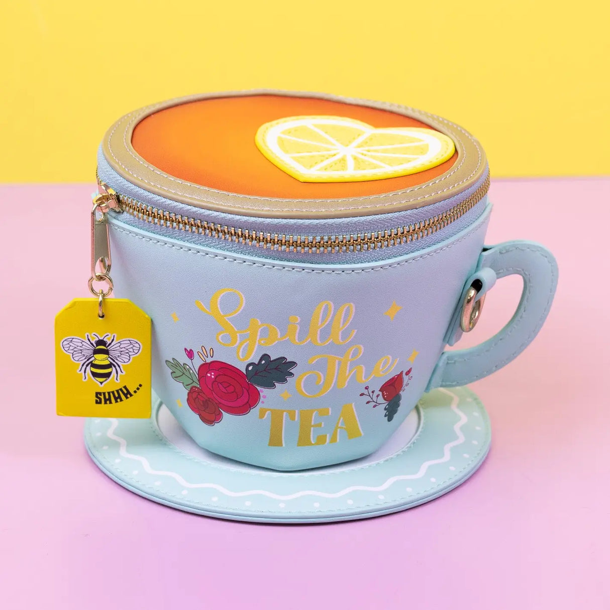 Handbag | Lemon Tea cup-shaped crossbody bag with lemon slice detail, zipper closure, and floral "Spill The Tea" design.