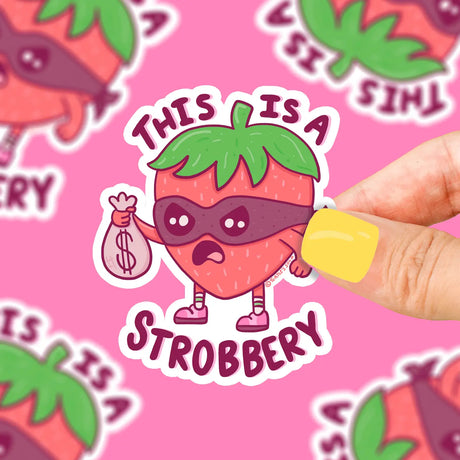 This is a Stroberry Sticker shows a cartoon strawberry wearing a mask holding a money bag on durable vinyl.