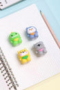 Lovely Animal Pencil Sharpener featuring cute assorted animal designs on graph paper next to pencil and notebook.