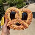 Handbag | Pretzel - plush pretzel-shaped crossbody bag with faux chocolate drizzle and glittery salt accents.