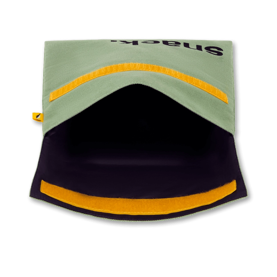 Open reusable food bag in moss green with yellow hook and loop closure showing black interior lining