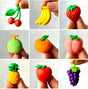 Japanese Eraser Fruit showing detailed, colorful miniature fruit erasers held between fingers, perfect for puzzles and decorations.