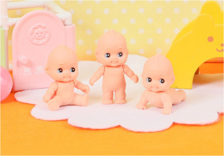 Japanese Eraser Kewpie Doll trio in different poses on a soft white mat with colorful background.