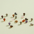 Carved Mushroom mini crystal mushrooms in various stones like rose quartz and tiger eye, playful and colorful decor pieces.