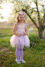 Pink Shimmer Unicorn Dress & Headband size 3-4 with ruffled sleeves, tulle skirt, and floral unicorn headband worn by smiling girl.