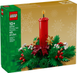 LEGO Christmas table decoration featuring a red candle, green foliage, red berries, golden stars, and white flowers