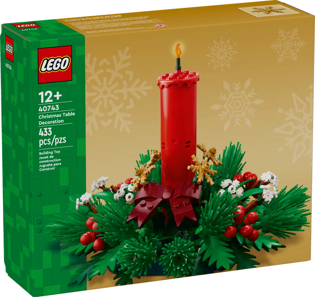LEGO Christmas table decoration featuring a red candle, green foliage, red berries, golden stars, and white flowers
