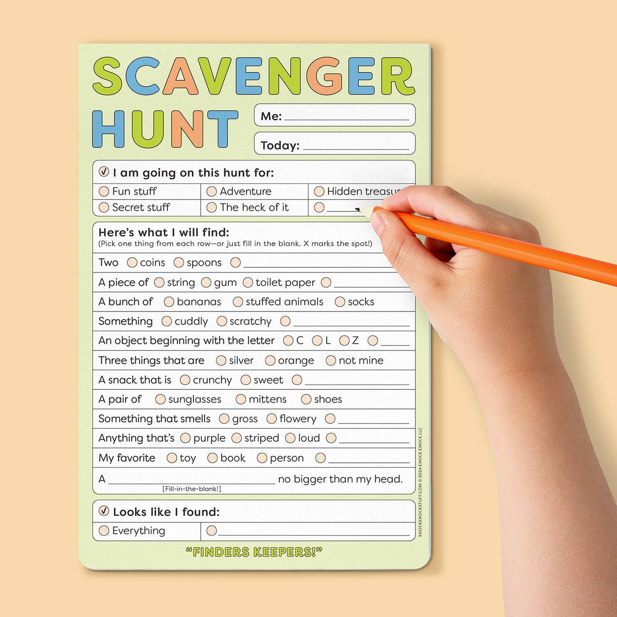 Child’s hand filling out colorful scavenger hunt notepad with playful prompts and checkboxes on light background