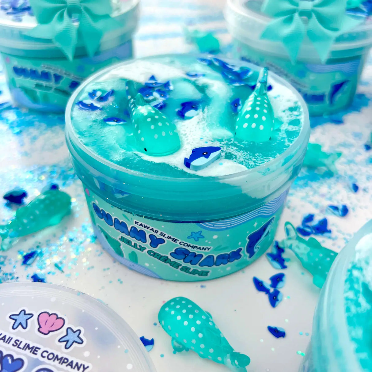 Gummy Shark Jelly Creme Slime with blue ocean swirl, shark fimo slices, white meringue, and whale shark charms.