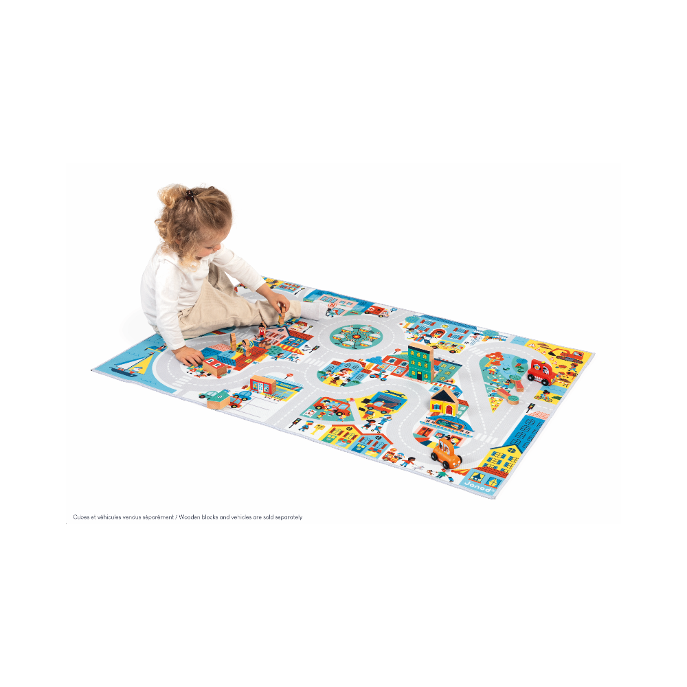 Child playing on colorful Crossroads City Play Mat featuring roads, buildings, and vehicles for imaginative urban play.