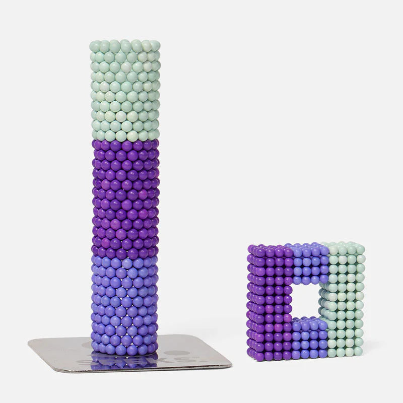 Speks. Bolds. Audacious showing colorful matte magnetic balls stacked in creative tower and square shapes.