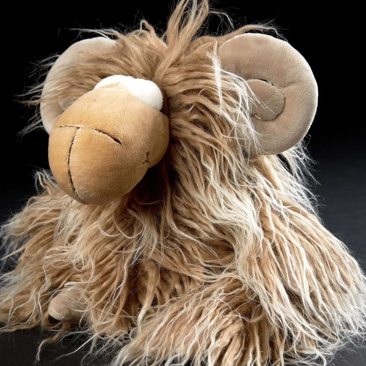 Soft plush Mufflon Muff toy with shaggy fur and curled horns, perfect for kids aged 12 and up.