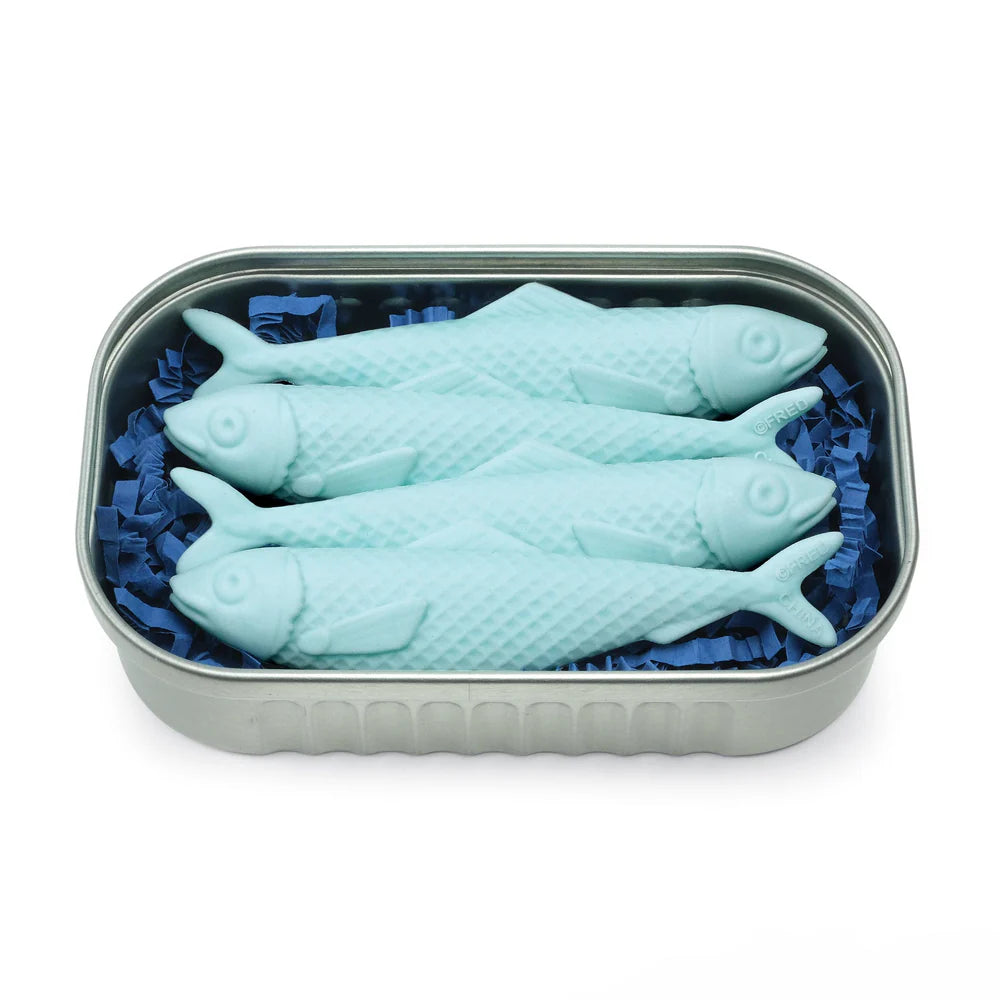 Set of four light blue fish-shaped erasers neatly arranged in a silver tin with blue paper filler.