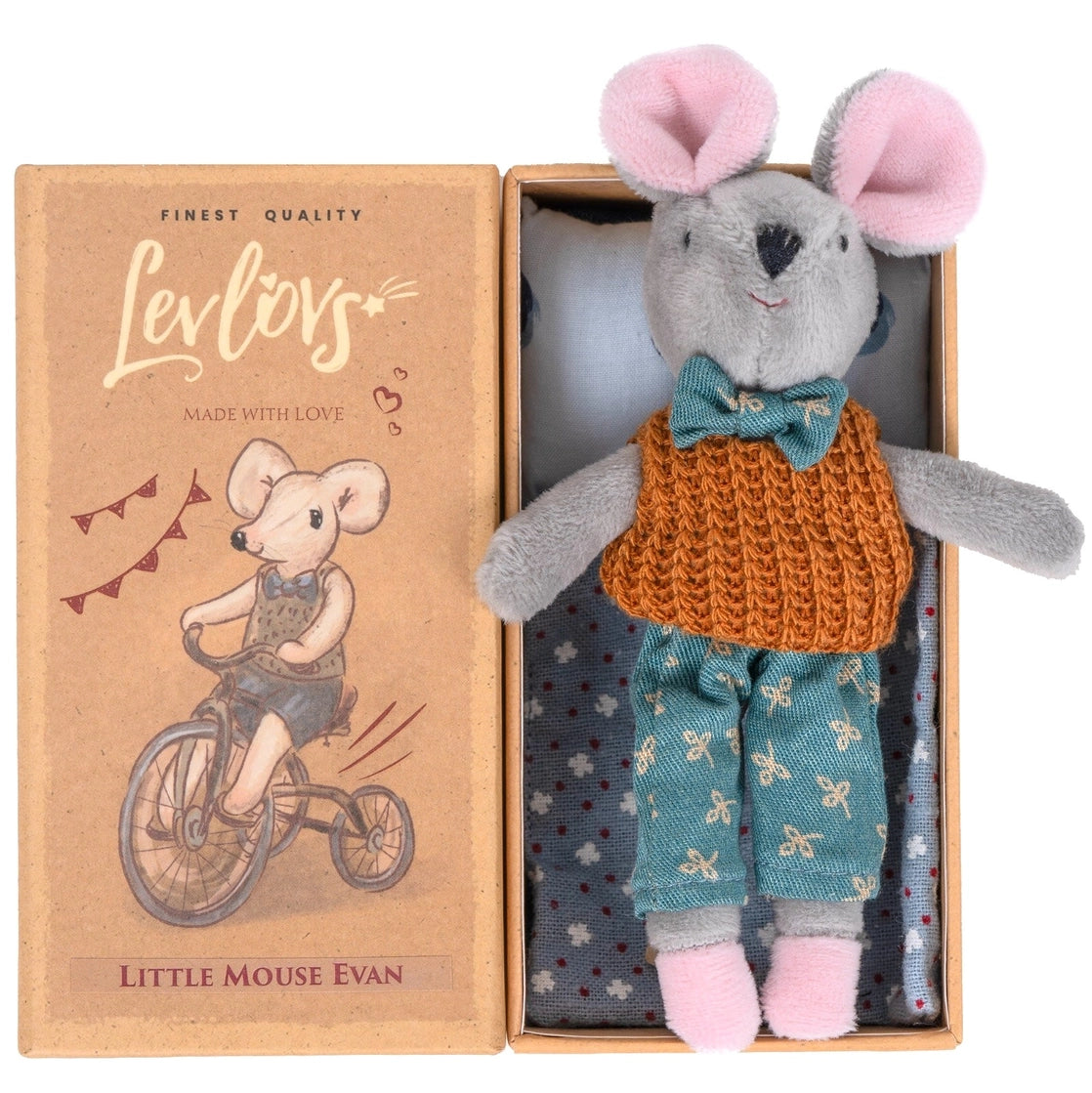 Plush mouse doll wearing knitted vest and shorts, lying in a box with illustrated cover showing mouse on a tricycle.