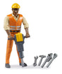 Construction Worker with Accessories toy figure wearing safety gear and holding a pneumatic hammer with additional tools.