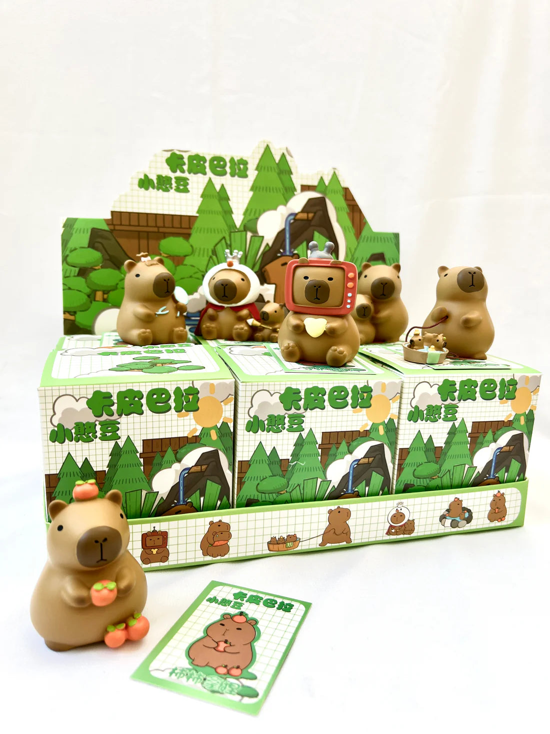 Capybara Figurine Vol 1 Blind Box showing various adorable collectible capybara figures in mystery packaging.