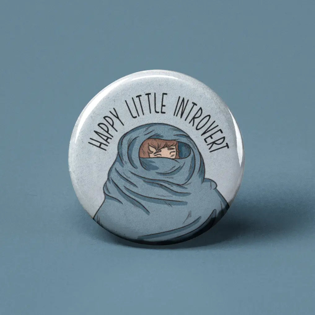 Button | Happy Little Introvert with illustration of a person wrapped in a cozy blanket, expressing introverted comfort.