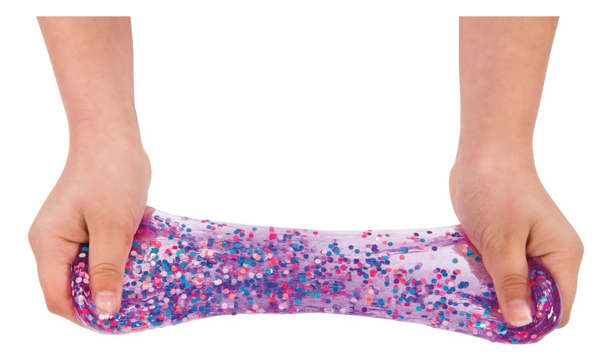 Hands stretching colorful Mix-Ins Slime filled with rainbow confetti dots in a clear, resealable jar for slime play.