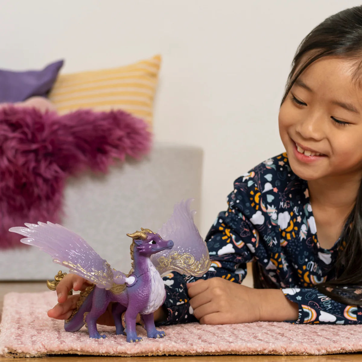 Child playing with Eldrador Creatures Night Sky Dragon toy with glittering wings and golden star on forehead.