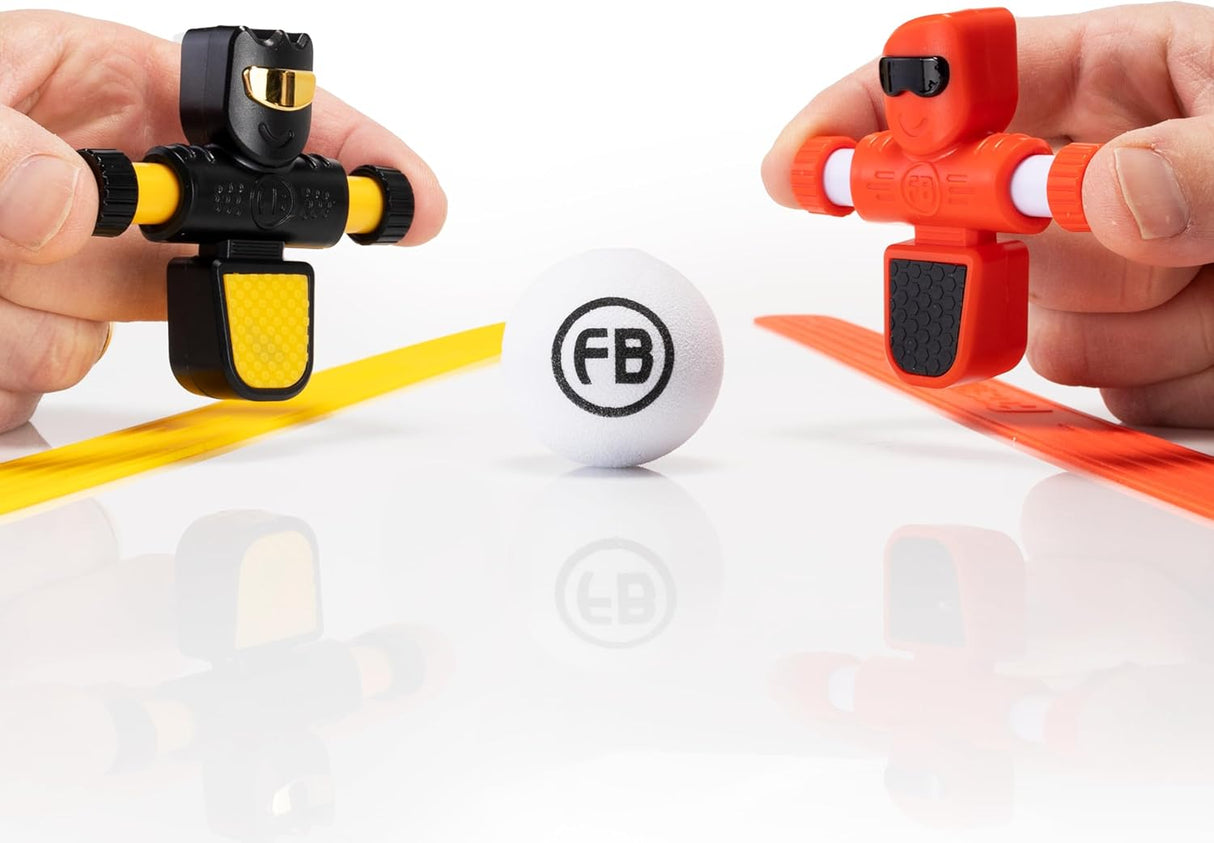 Foosbots 2 Pack shows black and orange Foosbot figures with silicone goal lines and ball ready to play.