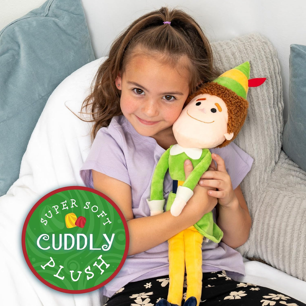 Young girl hugging the 21" Buddy the Elf plush, a cuddly and soft holiday toy perfect for all ages.