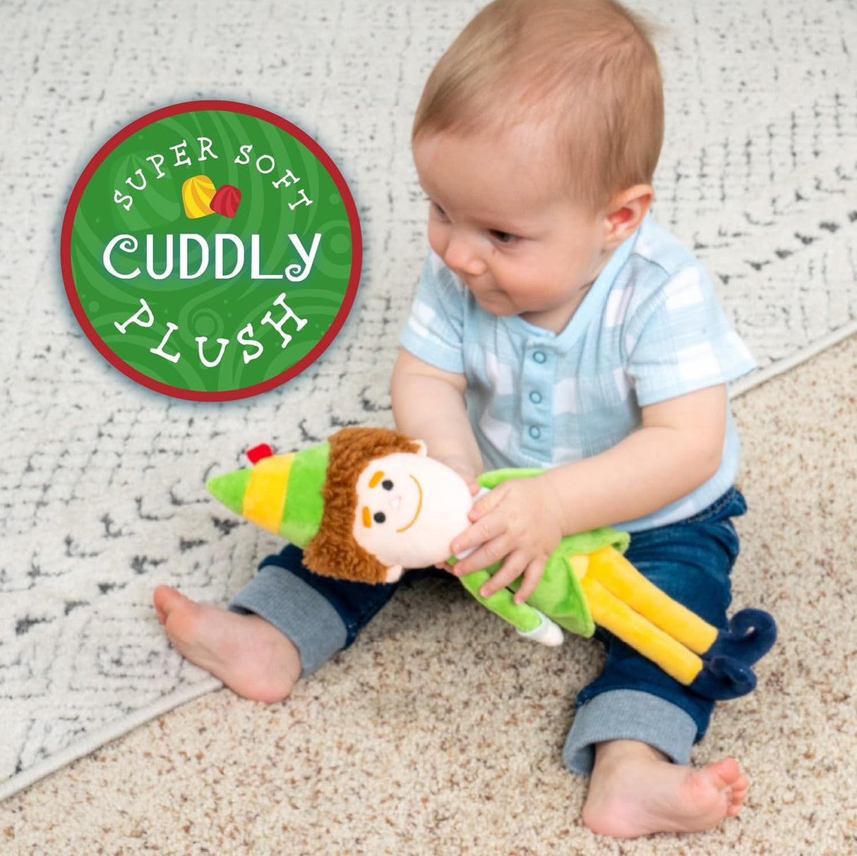 Buddy the Elf | Small plush toy held by baby, featuring embroidered face and pointy elf hat, 13.5 inches cuddly plush.